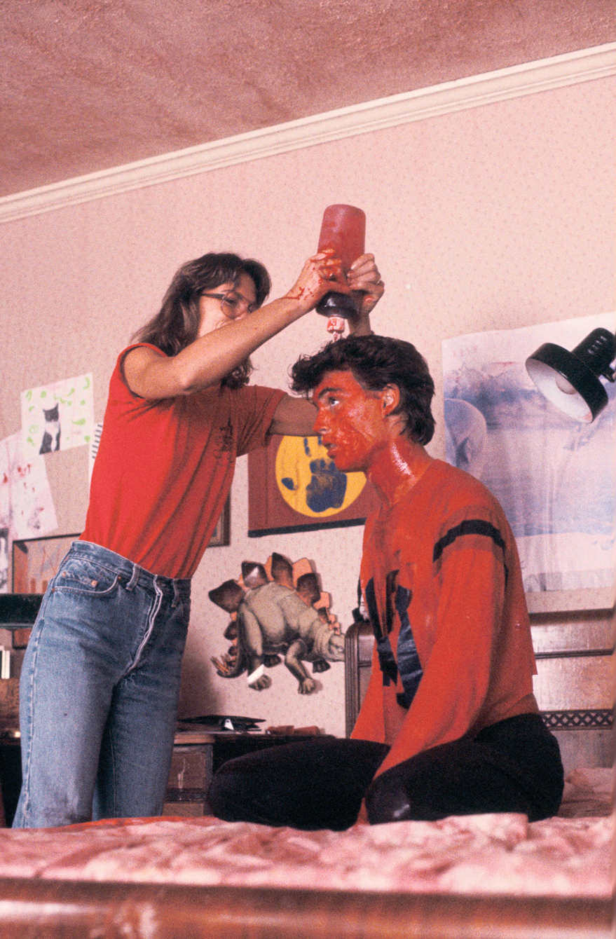 A crew member applies fake blood to Johnny Depp prior to a scene in A Nightmare on Elm Street (1984).