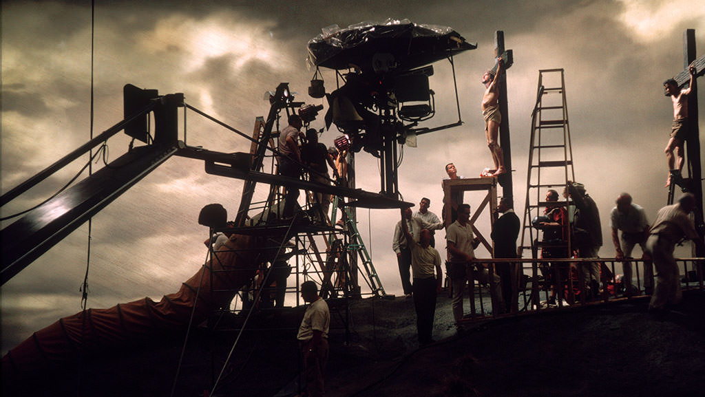 Crew members prepare for a scene with Max von Sydow (center on the cross) in The Greatest Story Ever Told (1965).