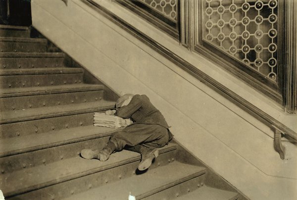 “Newsboy Asleep On Stairs With Papers.

Location: Jersey City, New Jersey”