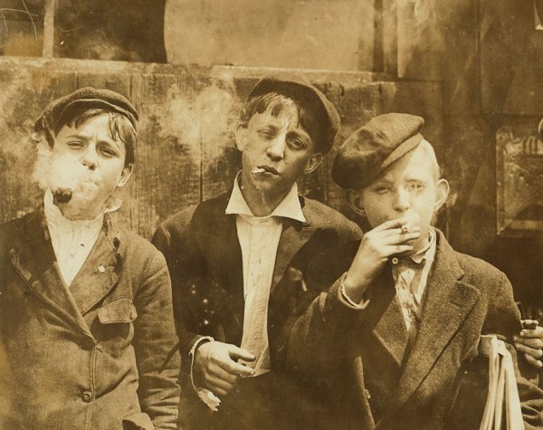 “11:00 A. M . Monday, May 9th, 1910. Newsies At Skeeter’s Branch, Jefferson Near Franklin. They Were All Smoking.

Location: St. Louis, Missouri”