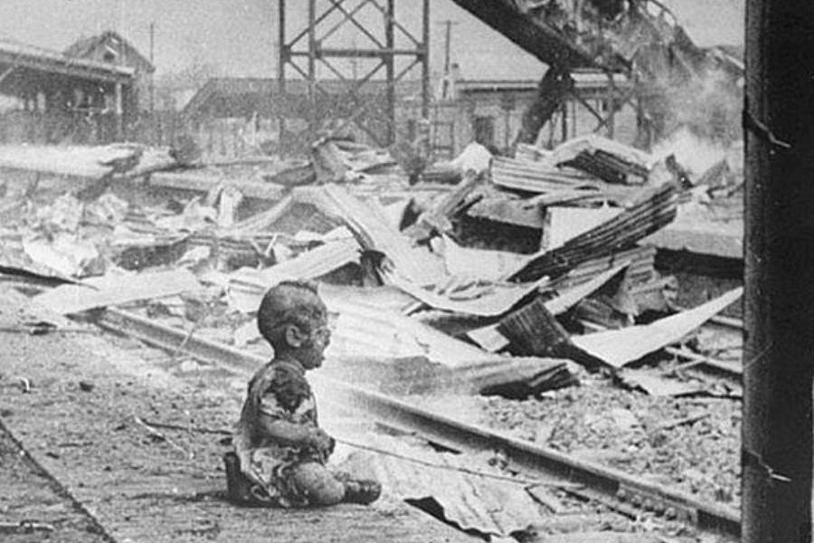 A baby sobs alone in the street after a Japanese airstrike on China, 1937.