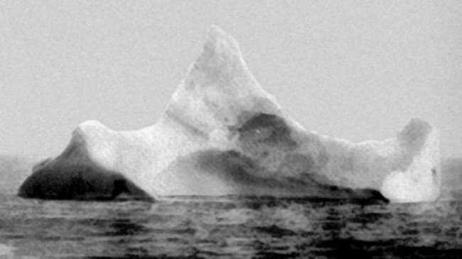 An iceberg with black and red paint on the side. It's thought that this is what sunk the ill-fated Titanic. (1912)