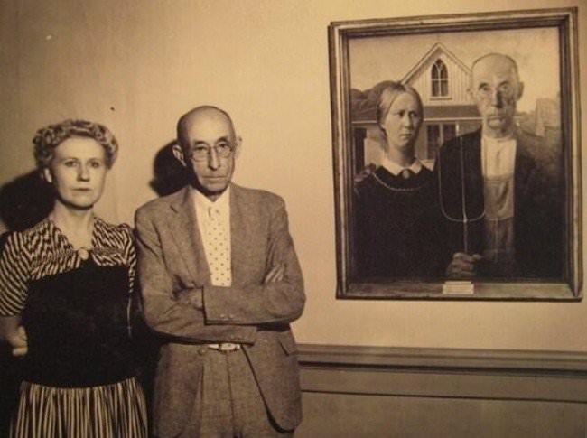 "American Gothic" models (the man's wife is absent) stand next to the famous Grant Wood painting. The lady to the left of the man his daughter.