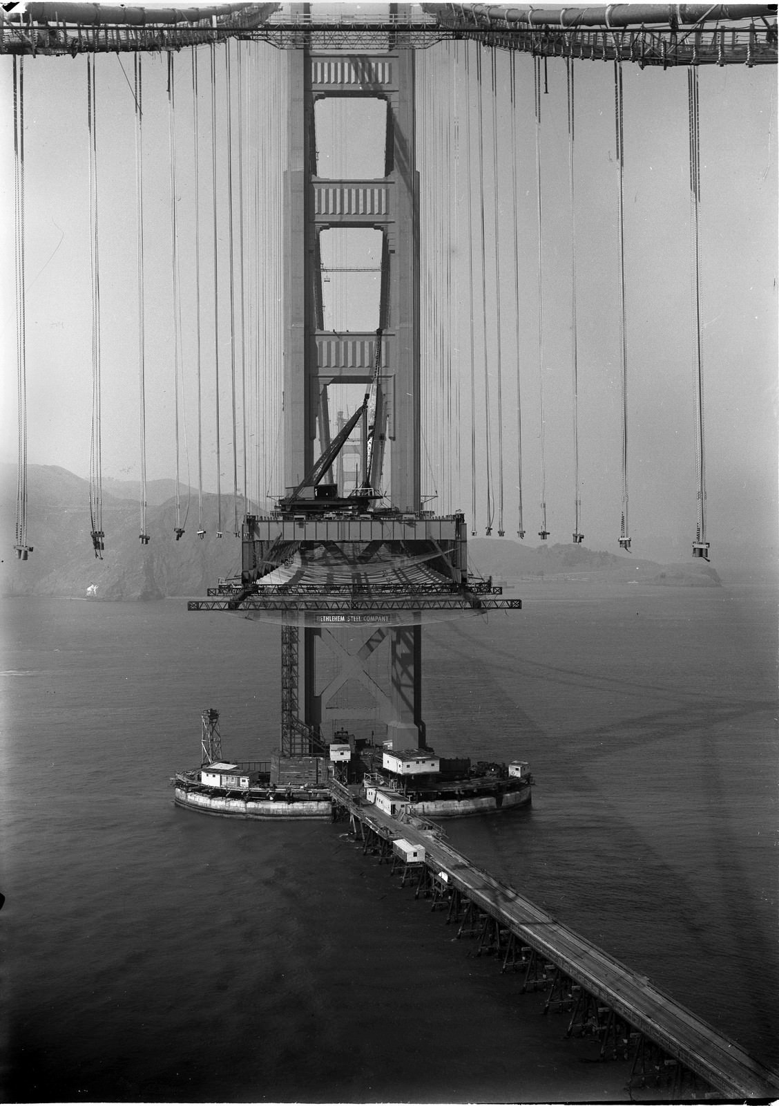 An eerie photo of the Golden Gate Bridge mid-construction, 1935.