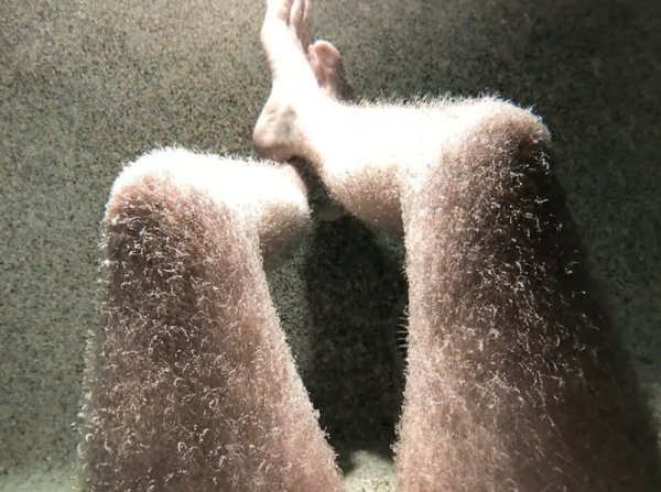 Hairy legs in a hot tub.
