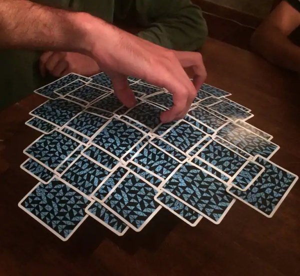Cards suspended in the air, held together by nothing other than the way they overlap.