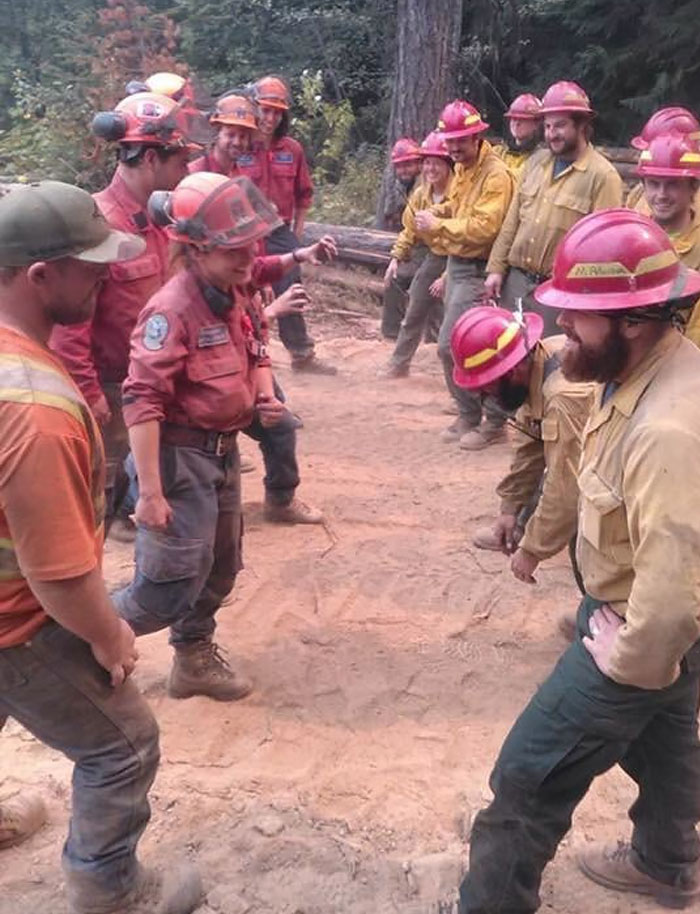 Canadian (Left) And American (Right) Firefighters Meet At The Border While Fighting The Horns Mountain Fire
