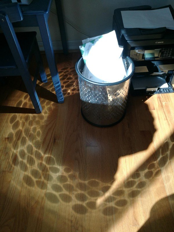 The light reflected off of this garbage can.