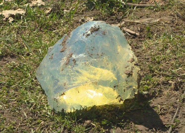 A shiny, transparent object with no origin or definition.
Two sisters from Kitchener, Canada found this rock buried in their backyard. They were originally looking for worms for a fishing trip and found this buried deep down.

They took it to a gem expert, who confirmed that it wasn’t a gem or a meteorite. The object is in fact a type of glass sold in a variety of colors and generally used as a garden ornament.