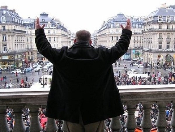 “In Paris, France during labor riots circa 2006. During a peaceful tour of the opera house, an army sized crowd suddenly formed and erupted outside. A door to the balcony was open and I, alone on the balcony, approached the congregation, lifted my arms like so much dictator, and shouted “Vivre la France! Vive la revolution!” They cheered insanely and I booked it out of there seconds before security swarmed the balcony.”