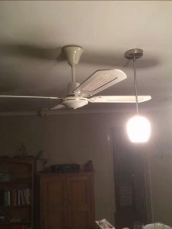 ceiling fan that hits the light next to it