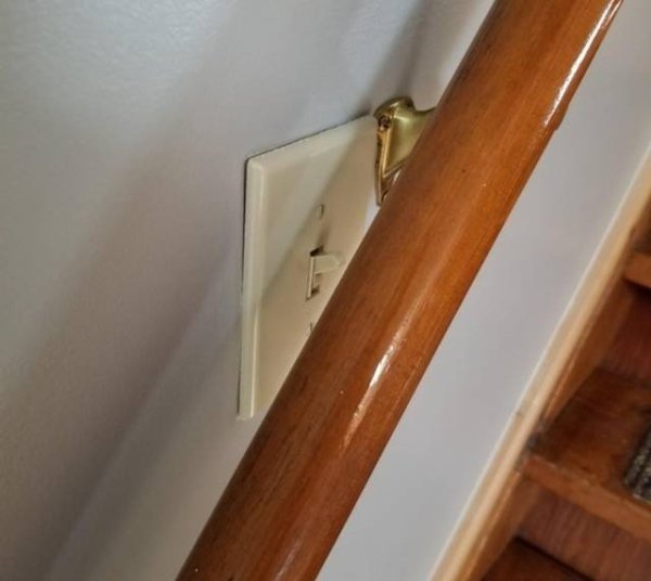 light switch hidden by the bannister