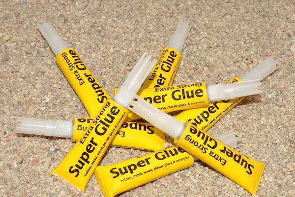 You can close wounds with superglue.
This isn’t highly recommended, but when you have no other choice, it’s the only option you’ve got. By forcing the two parts of your skin together and glueing it, you’re preventing further injury and infection and it’ll allow you to find help, unhindered.