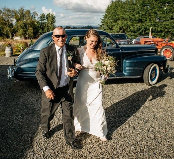 “My parents had to postpone their wedding due to my dad’s aplastic anemia diagnosis. He was given a 3% chance to live, and when he did he was told he couldn’t have kids. Here he is walking me down the aisle 39 years later on my parents’ original wedding date.”