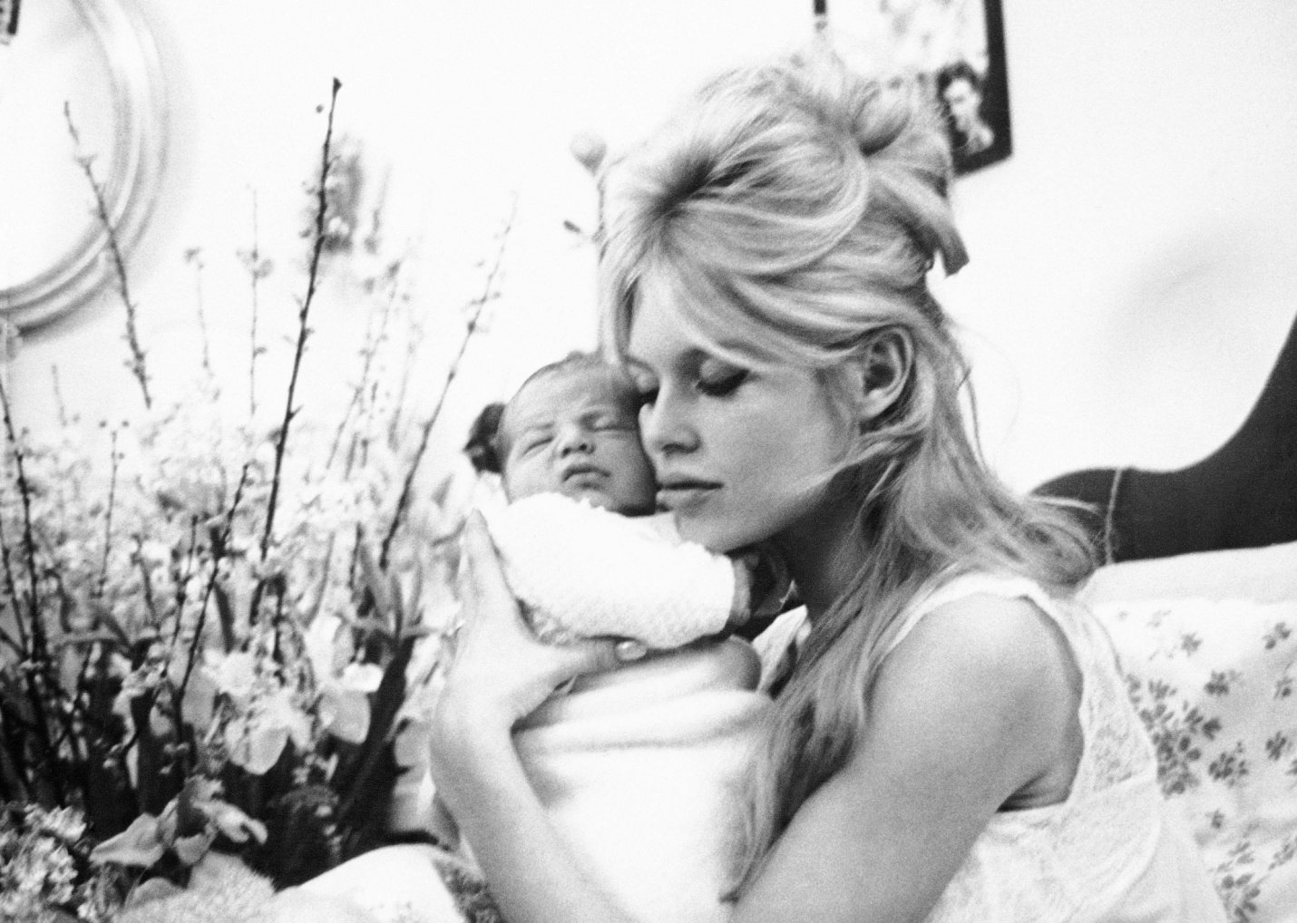On 11 January 1960 Bardot gave birth to her only child, Nicolas. Here she is cuddling him in her Paris apartment..