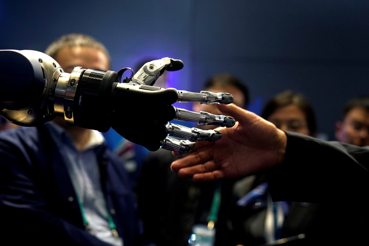 A person shaking hands using a prosthetic hand