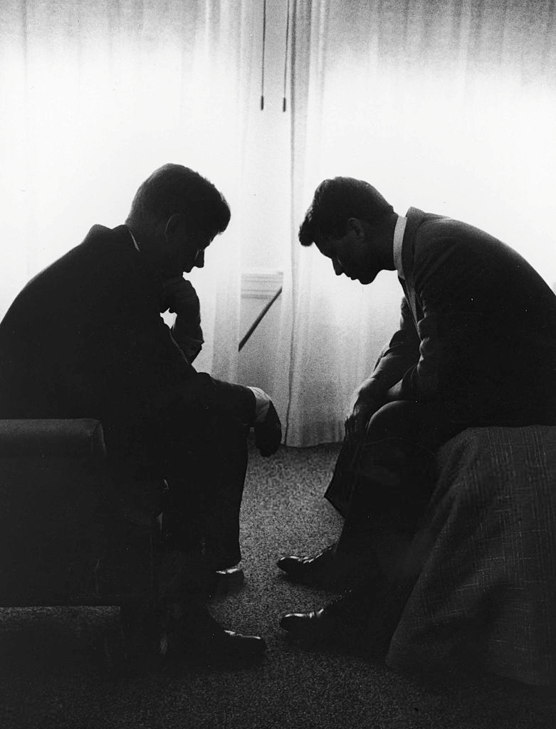 John F. Kennedy consults with his brother Robert Kennedy during campaigning. 1960