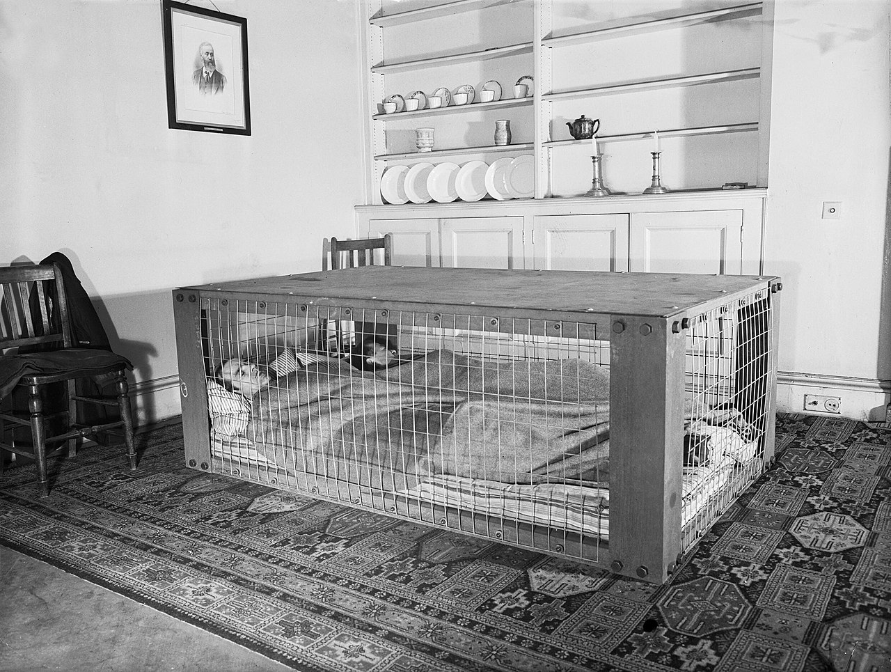 A British couple sleeps inside a “Morrison shelter” used as protection from collapsing homes during the WWII ‘Blitz’ bombing raids March 1941