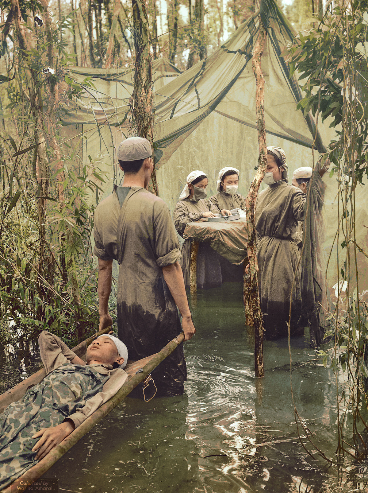 A victim of American bombing, ethnic Cambodian guerrilla Danh Son Huol is carried to an improvised operating room in a mangrove swamp on the Ca Mau Peninsula, September 15, 1970