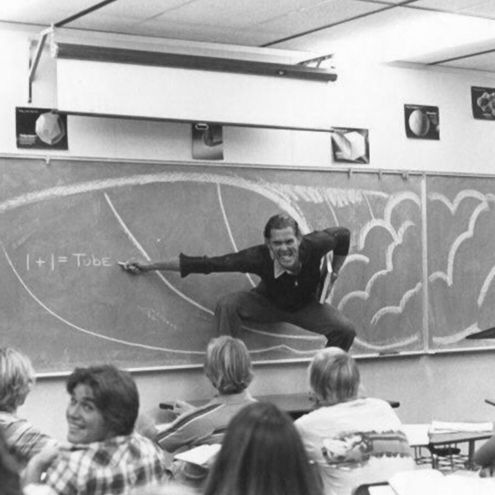 A photo of a high school math teacher explaining the physics of surfing in the 1970s