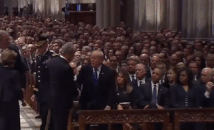 George Bush sneaks Michelle Obama a piece of candy at his father’s funeral