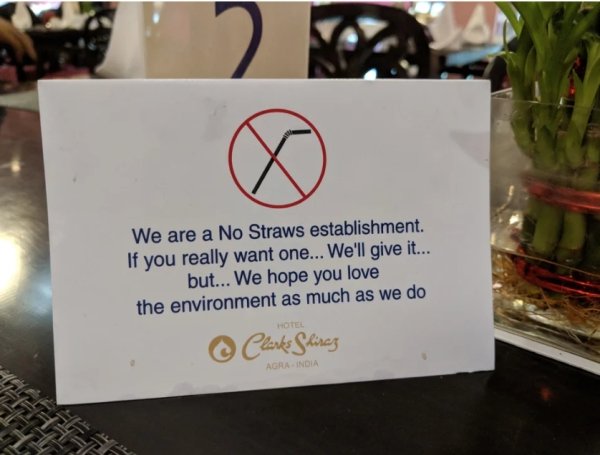 sign - We are a No Straws establishment If you really want one... We'll give it... but... We hope you love the environment as much as we do Hotel Clarks Shinez Agra India