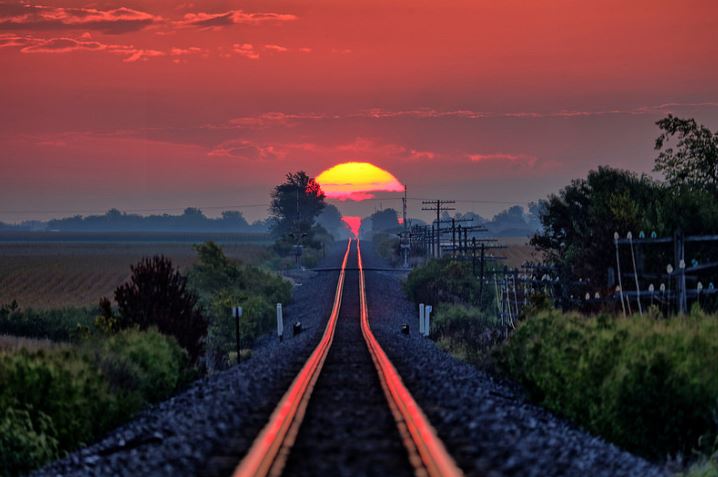 perfect timing sun on railroad tracks