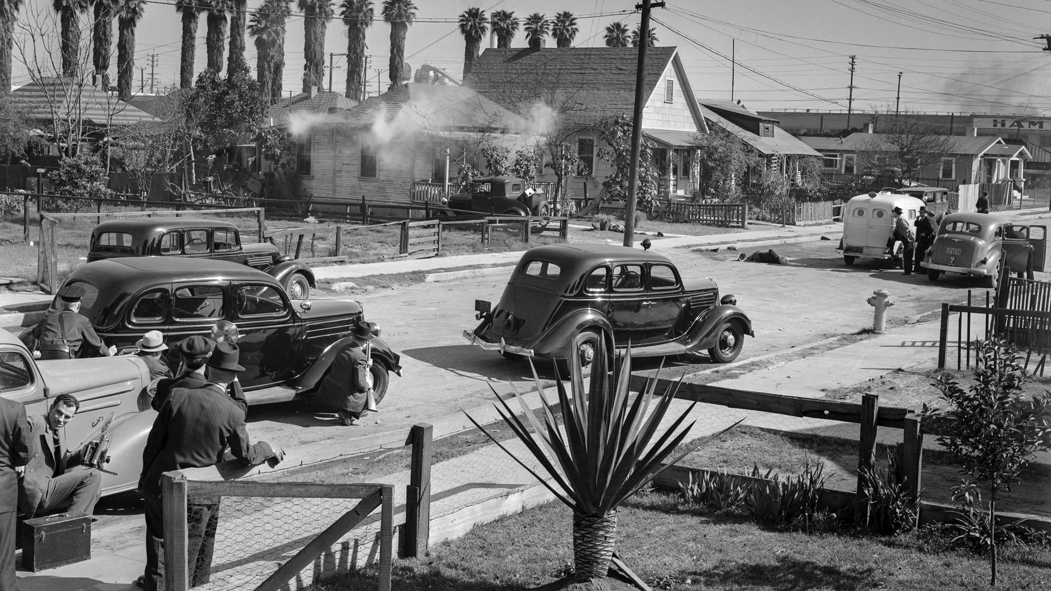 Police trade shots with barricaded suspect, Los Angeles, Feb. 17, 1938