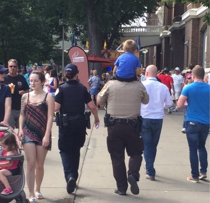 “This little guy lost his mom at the state fair, and the policeman carried him on his shoulders to help him look for her.”