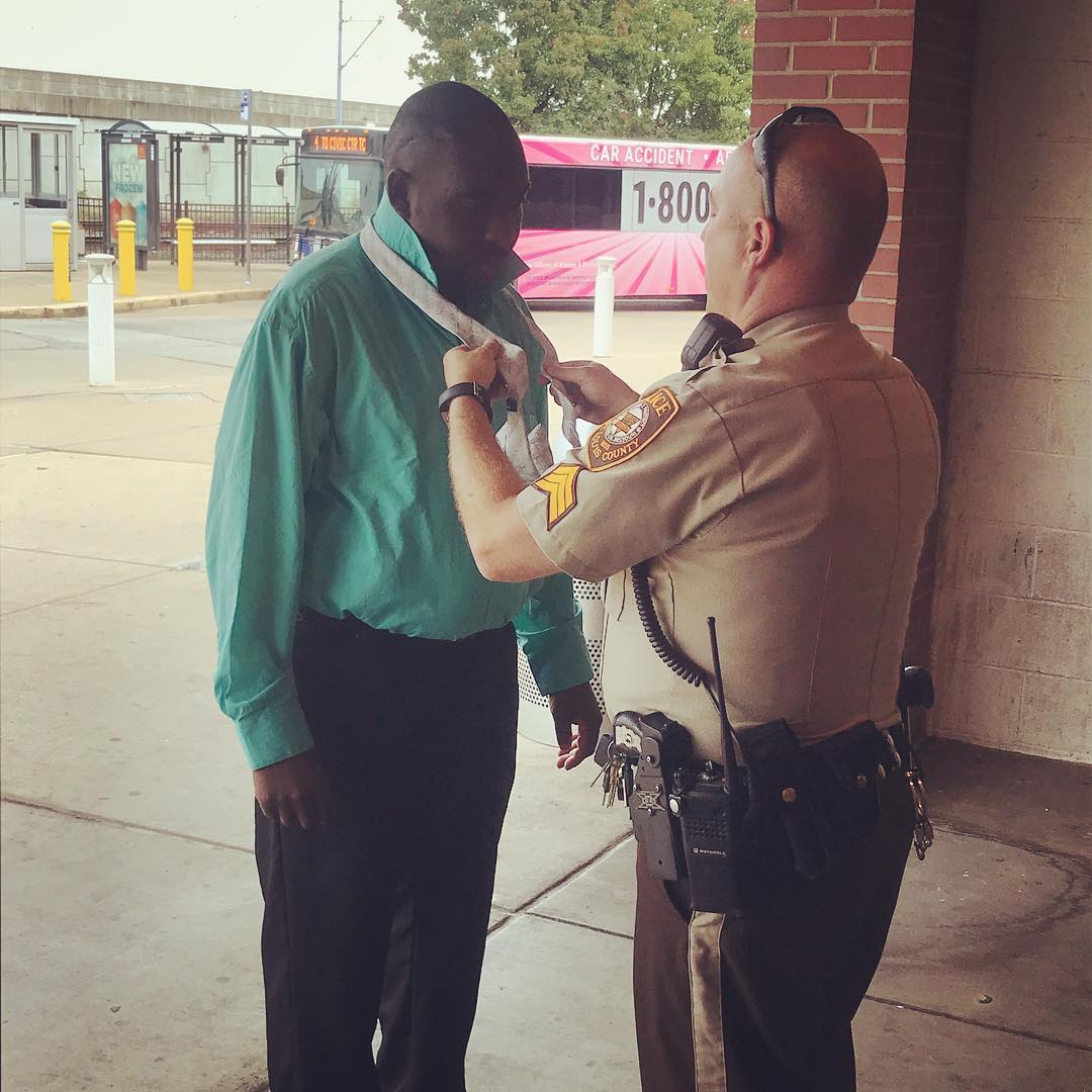 This man was going for a job interview and stopped to ask for some help with his tie. This officer volunteered.