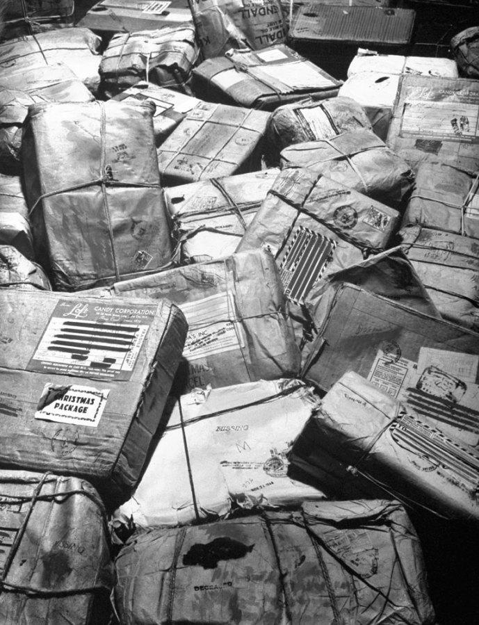 Christmas packages destined for soldiers who have been killed or reported missing in action await “return to sender” stamps. New York City, 1944
