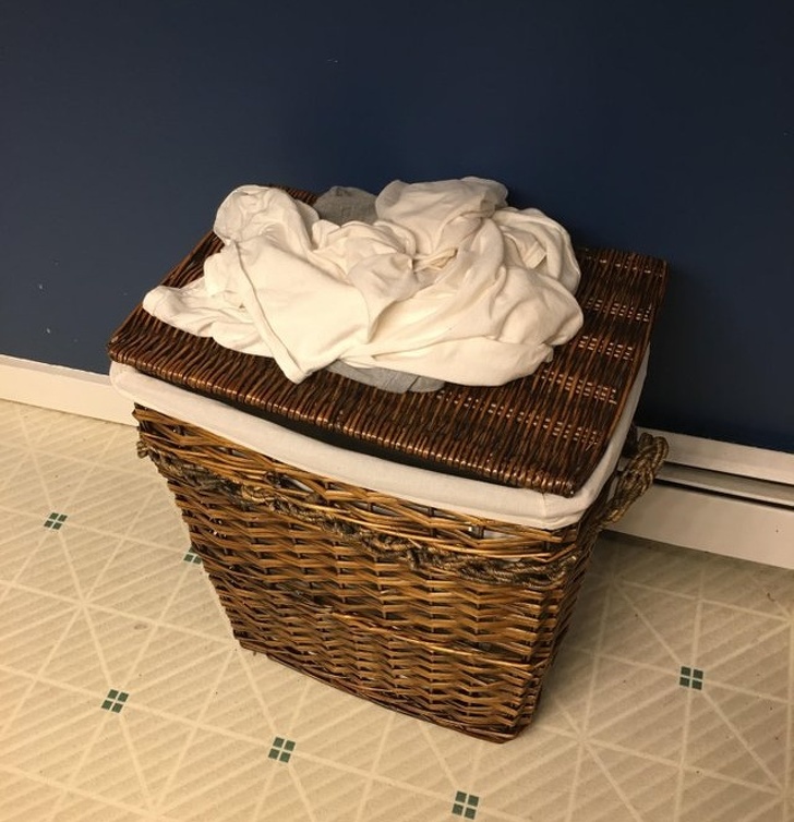 “My husband’s dirty clothes on top of an empty laundry hamper”