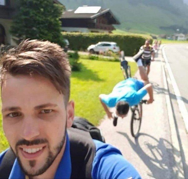 Baby falling in leaves. Man on bikes taking selfie with man behind him falling and someone behind.