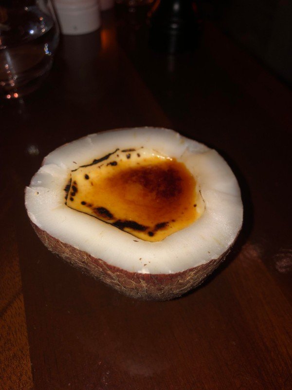 This coconut creme brûlée is served inside a small coconut.”