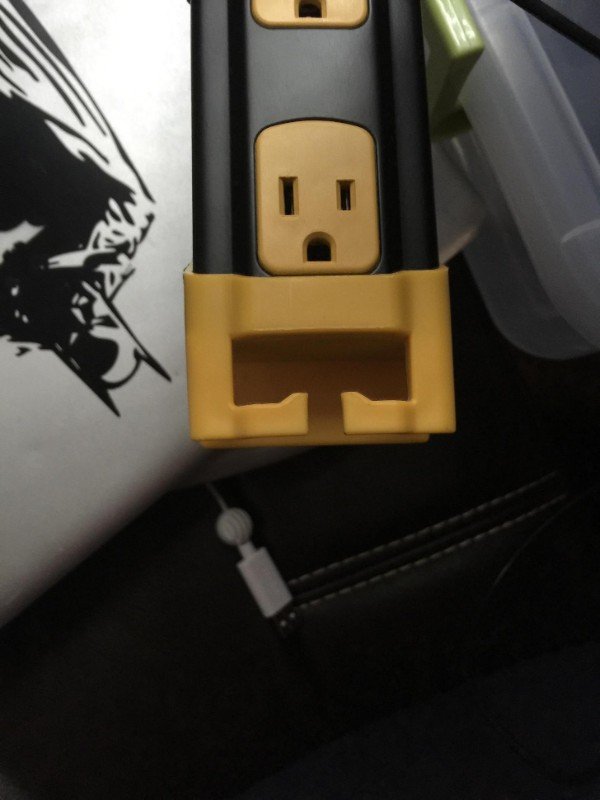 This power strip outlet looks like a tough guy trying to flex his muscles.