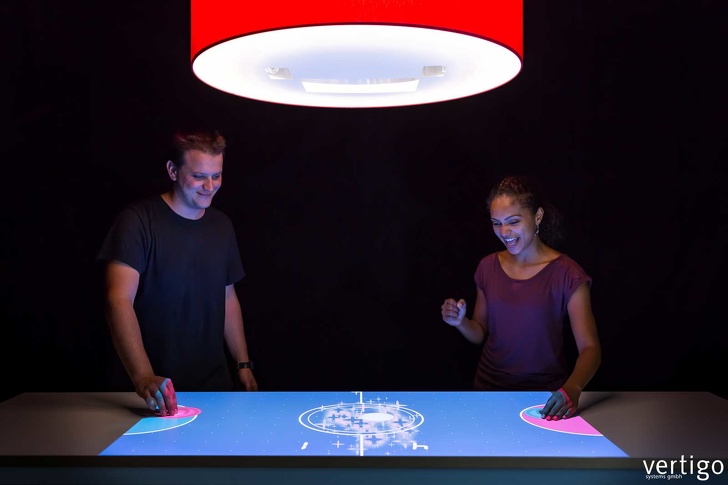 This interactive lamp projects onto horizontal surfaces and reacts to hand movements.