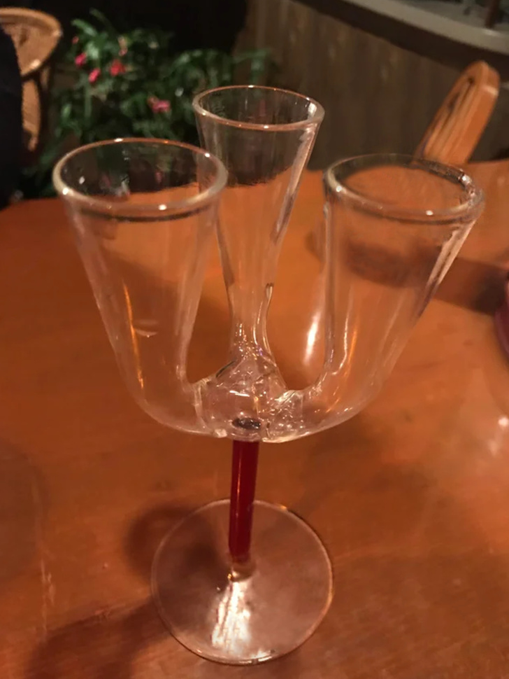This is an old glass where all 3 small glasses are connected. You can drink from any of them and the drink drains through the bottom where all ’shots’ are connected.