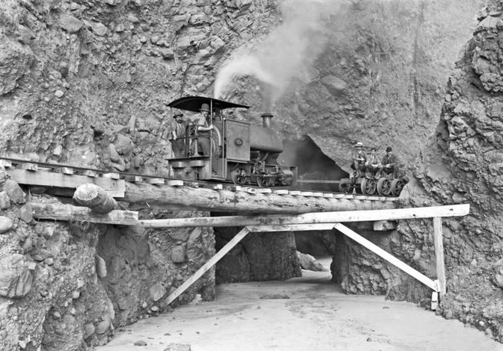 1915 - Steam railway locomotive Sandfly traveling along a trestle bridge on the Karekare beach tramway