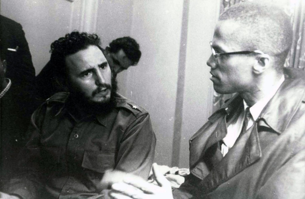 Fidel Castro and Malcolm X converse.
