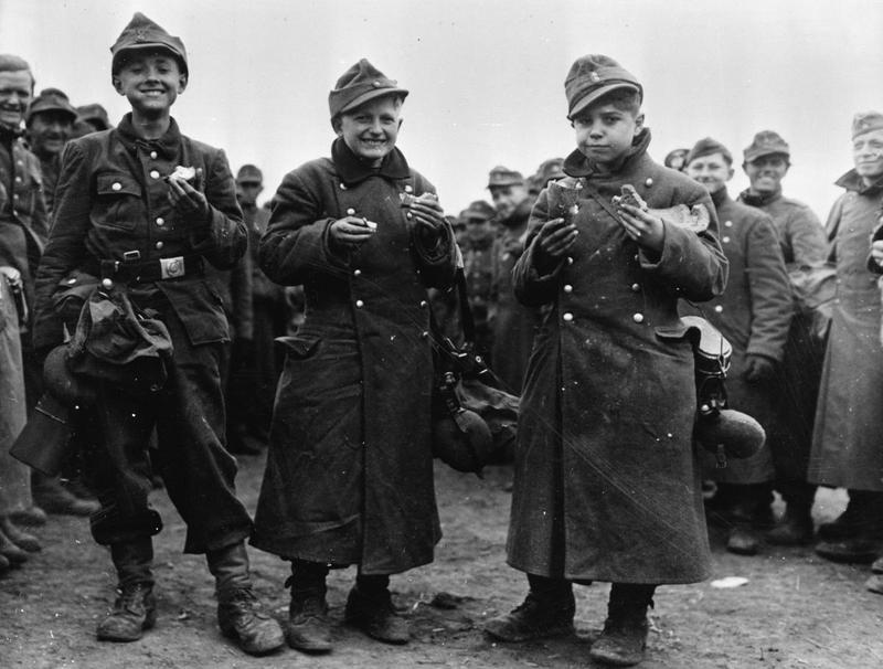 Hitler Youth enjoy a meal after their capture by American forces.