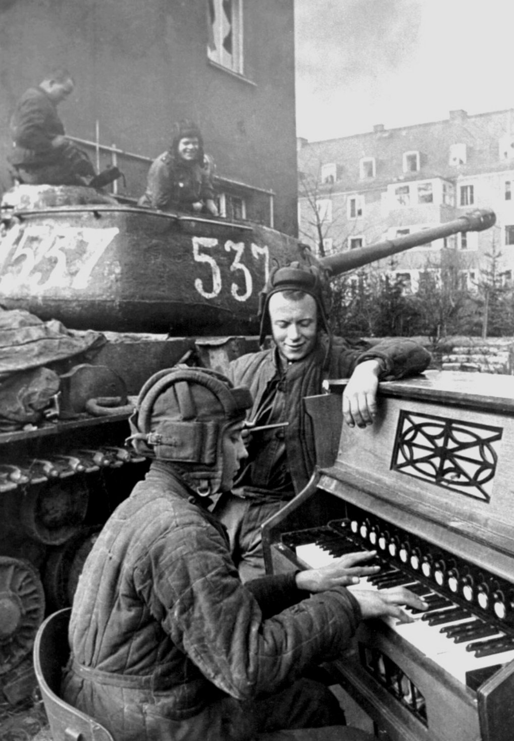 A Soviet tanker plays a piano during WWII.