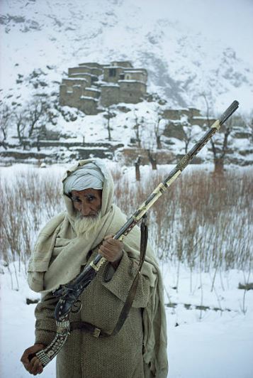 An Afghan man presents a firearm dating back to the East India Company.