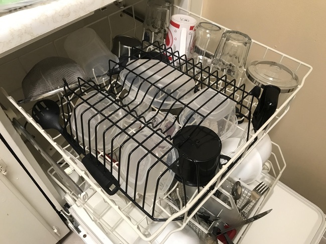 “I use an upside down metal dish rack to keep my plastic food containers from flipping upside down in the dishwasher.”