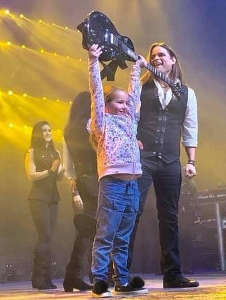 “Brought my little girl to her first rock concert today, the Trans-Siberian Orchestra. The band brought her on stage to bow at the end of the show with them, and gave her a signed guitar, pick, and setlist.”