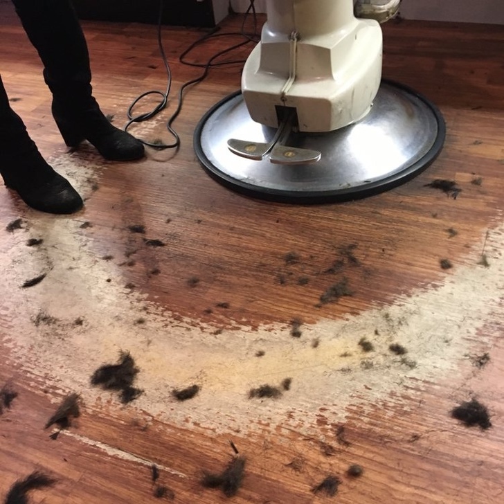 The floor of a barber’s shop worn down from walking around the chair