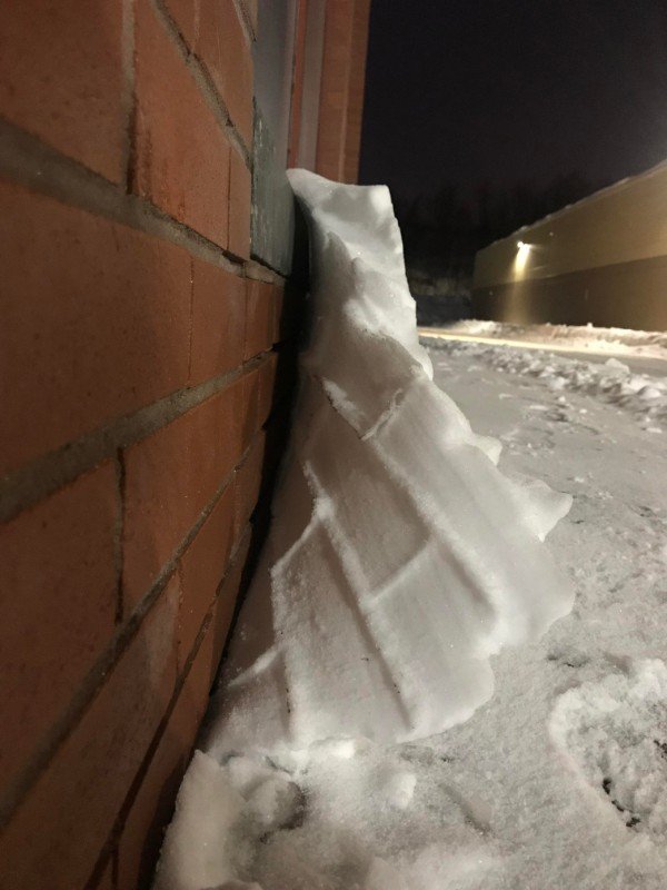 Snow peeling off of the brick.