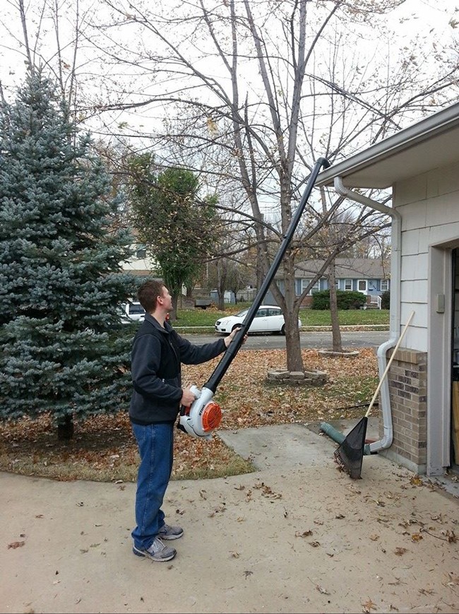 Use a leaf blower and PVC pipes to clean gutters without a ladder