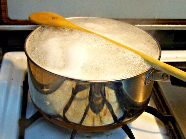 Keep a pot from bubbling over. Placing a wooden spoon over the top of boiling water will stop it from boiling over by bursting the bubbles.