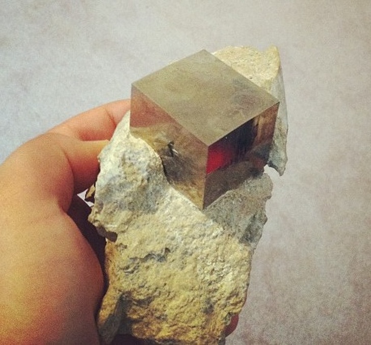 “This is a perfect cube of pyrite, in its natural rocky matrix.”