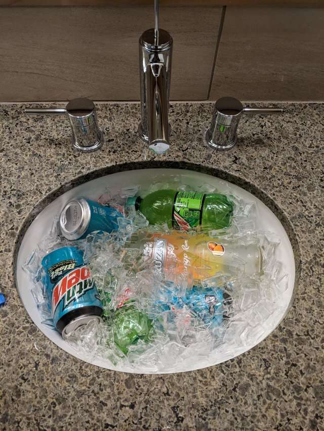 If a hotel room doesn’t have a fridge, keep your booze (and other drinks, I guess) cold by filling the bathroom sink with ice and using it as a makeshift cooler.